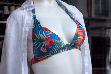 Closeup of tropical printed bikini on mannequin in a fashion store showroom