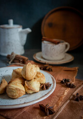 Morning coffee from the kettle in a cup with biscuits and spices