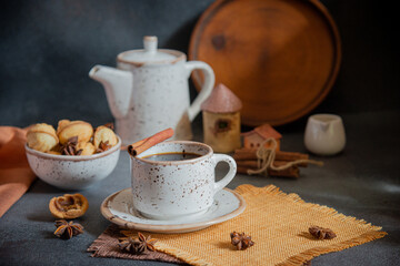 Morning coffee from the kettle in a cup with biscuits and spices