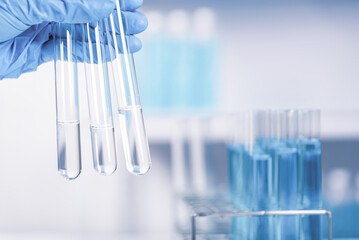 chemist, scientist hand holding test tube with microscope in laboratory background, science...