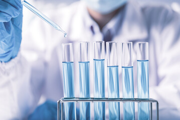 chemist,scientist hand pick up and dropping chemical liquid into test tube, science research and development concept