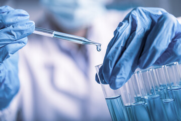 chemist,scientist hand pick up and dropping chemical liquid into test tube, science research and...