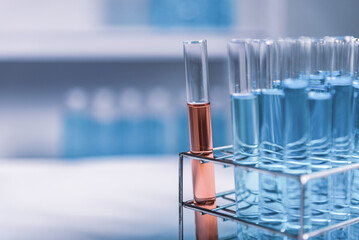 red test tube in blue rack, science research and development concept