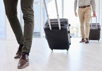 Time to take a deep breath and relax. two businessmen on making their way to the airport from work.