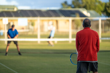 Amateur Tennis player, playing tennis at a tournament and match on grass in Europe