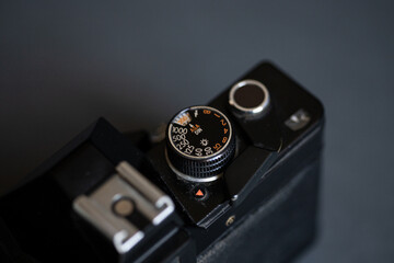 Vintage black retro film camera with black dials and white and orange numbers