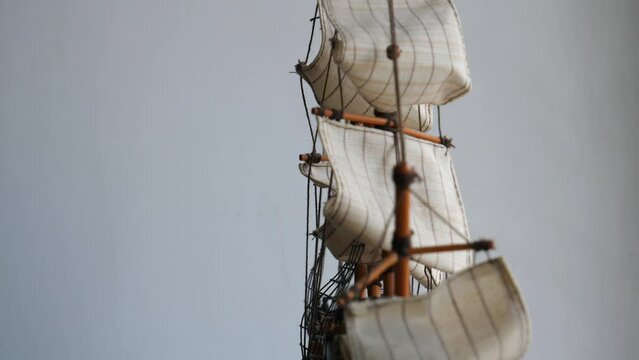 Rotation Of Sailing Masts Of Scale Model Wooden Ship On A White Background 4K Video 
