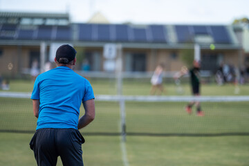 Amateur playing tennis at a tournament and match on grass in Melbourne, Australia	