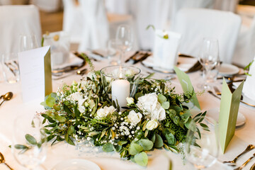 Schön gedeckter Tisch mit Blumenschmuck bei einer Feier