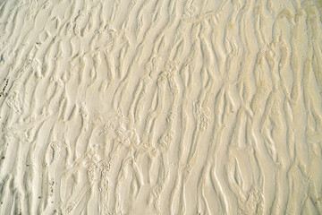 Sand pattern on the beach. Abstract background and texture for design.Natural background