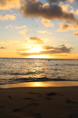 Naklejka na ściany i meble landscape with mountains, clouds, beaches, sky, and orange skies of beautiful Hawaii