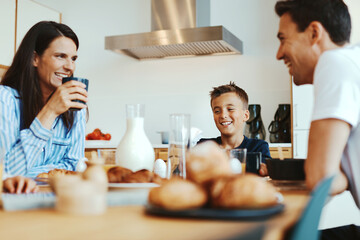 Family laughing together at breakfast