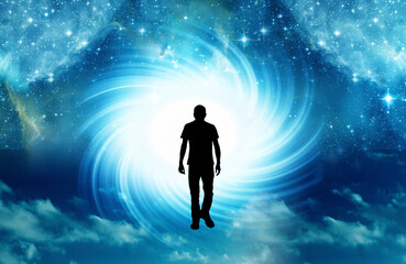 Fototapeta na wymiar silhouette of man walking toward light cosmic whirl like spiritual concept, universe portal, mind and spirit 