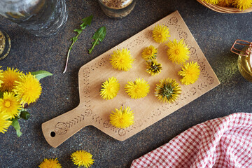 Fresh dandelion flowers on a table, top view