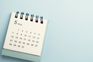 close up of calendar on the blue table background, planning for business meeting or travel planning concept