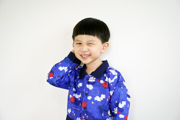 Asian White child with shy and smile face isolated on white background. Portrait of Cute Asian boy in a blue shirt smiling and looking at the camera.