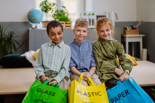 Children separating rubish in to three bins.