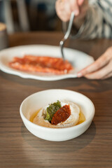 Whipped ricotta pesto, tomato and basil in a plate