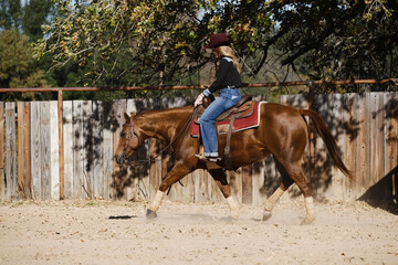 Cowgirl riding in outdoor arena, western industry lifestyle in Texas.