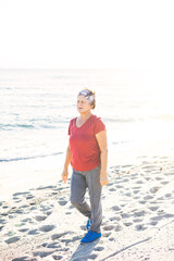 Senior woman exercising, walking at the beach