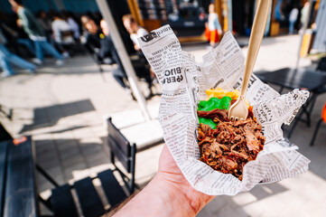 man holds pulled pork and french fries with sauce in hands. Street food, fast food outdoor