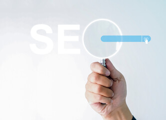 Businessman hand use magnifying glass Search On Virtual Screen Data Search Technology Search Engine Optimization. Searching for information. Using Search Console for data, info.