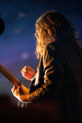 Band playing music and a gig in a venue, close up of a rock band playing guitars and instruments.