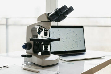 Medical laboratory, microscope and laptop computer on scientist office desk, Scientific and...