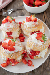 Pastry with whipped cream and marinated strawberries