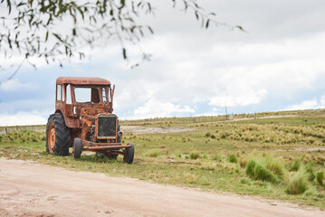 Old rusty tractor at the side of a country road. Image without people with copy space. Concepts:...