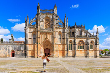 Woman tourist in front of The Monastery of Batalha- Portugal, Leiria- 2023