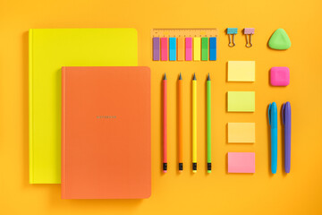 Bright school and office supplies on yellow background. Flatlay.