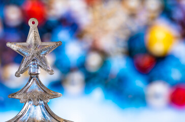 A toy Christmas tree on a Christmas background.