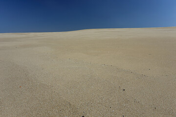 Fototapeta na wymiar Minimalist sea beach against blue sky