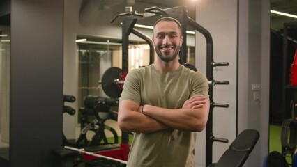 Smiling African American man personal fitness trainer invite to gym workout sportsman athlete welcome come here gesture invitation to join training posing crossed arms in gym sport club bodybuilder