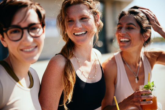 Smiling women hanging out after yoga class
