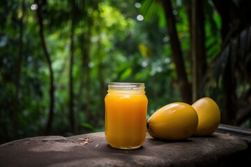 Mango juice and sliced mangoes on a wooden table. Generative Ai