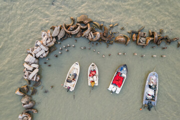 Karpen, Albania - August 12, 2022. Small boats moored in shallow water