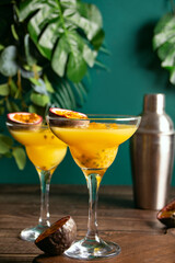 Fresh passion fruit maracuja alcoholic cocktail with ice cubes