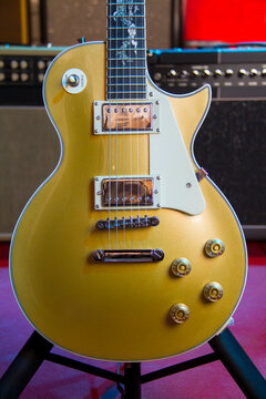 Solid gold top electric guitar Les Paul style with humbucker pickups.