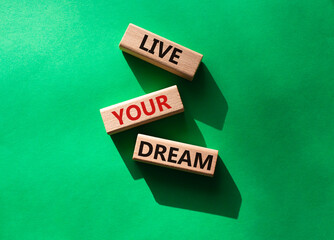 Live your Dream symbol. Wooden blocks with words Live your Dream. Beautiful green background. Business and Live your Dream concept. Copy space.