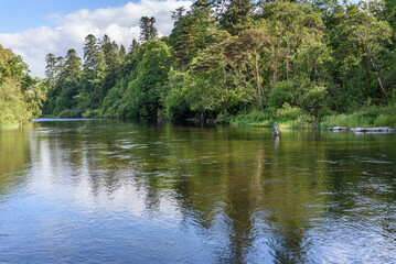 Fototapeta na wymiar Fishin in the river in the village of Cong, Ireland