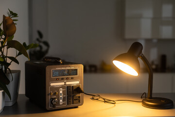 Portable power station charging tablet computer on table in living room