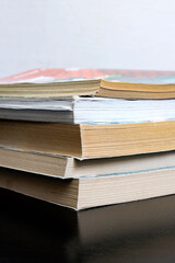 Stack of old books on wooden table