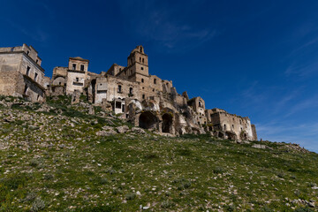 Craco, Basilicata. Abandoned city. A ghost town built on a hill and abandoned due to geological problems. Surreal look, horror film scenery. Panorama of the Calanchi Park.