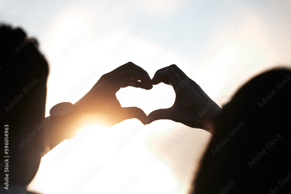 Poster you make me whole. an unidentifiable couple making a heart shape with their hands at sunset.