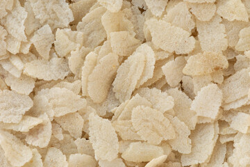 Poha, flattened rice background texture. Basis for Indian breakfast or snack (kanda poha, batata poha, poha chivda).