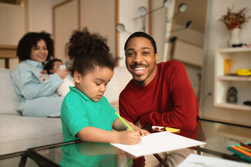 Happy black father spending time with his family at home