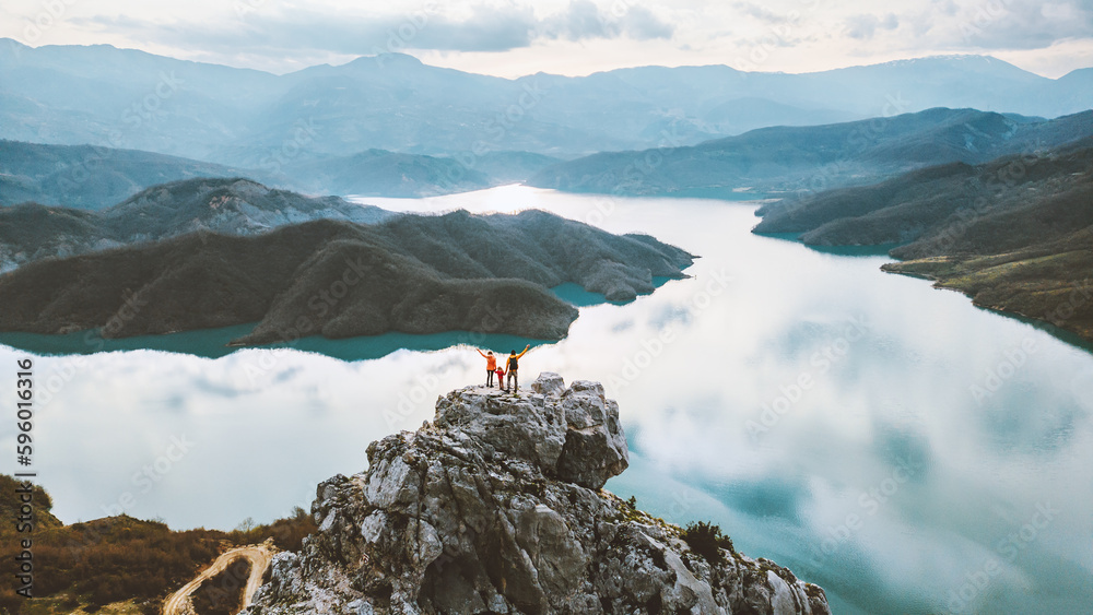 Wall mural aerial view family hiking in albania parents with child travel outdoor enjoying bovilla lake view ac