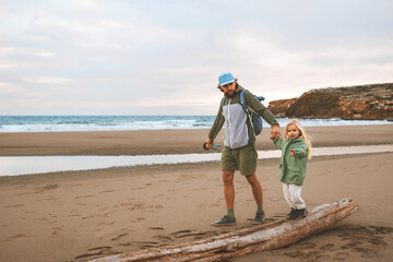 Family father walking with child on the beach summer vacations lifestyle travel together parent dad...